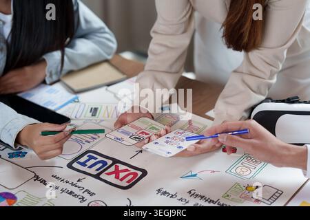 Three people collaborating on UI UX design for mobile app development Stock Photo