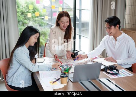 Asian UX UI design team collaborating on app development in modern office Stock Photo