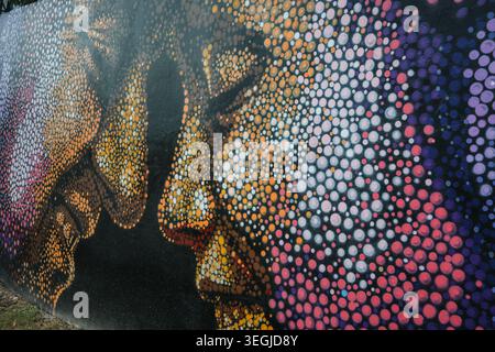 Montego Bay, Jamaica — November 28, 2025:Artistic pointillism style street art mural of human faces on a wall in Montego Bay, Jamaica. Stock Photo