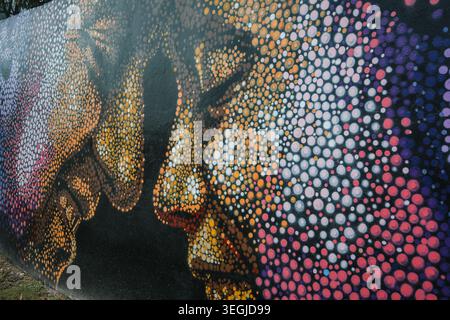 Montego Bay, Jamaica — November 28, 2025:Artistic pointillism style street art mural of human faces on a wall in Montego Bay, Jamaica. Stock Photo