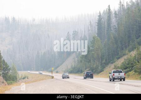 Cars on the US2 highway during a forest fire, Glacier, Montana, USA Stock Photo