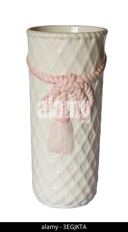 Close‑up of white porcelain vase featuring diamond‑patterned surface and raised pink rope with tassel design, glossy finish and cylindrical shape isol Stock Photo