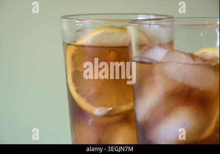 Two glasses of iced tea with lemon slices and ice. Stock Photo