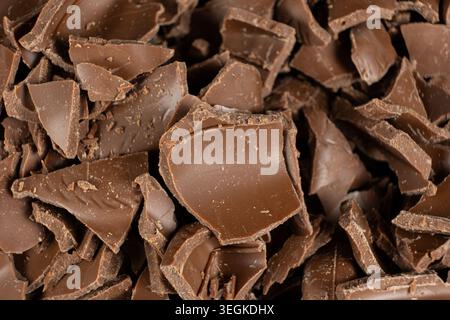 Macro texture of broken milk chocolate pieces pile background Stock Photo