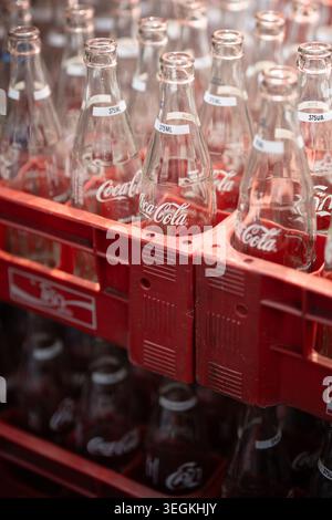 Red plastic Coca-Cola box with empty Cola bottles, reusable Coca-Cola bottles in Thailand. Stock Photo