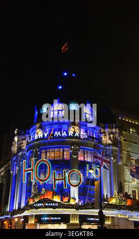 Christmas Ho Ho Ho decoration on BHV department store facade near Hotel de Ville in Paris, France, blue illuminatioin Stock Photo