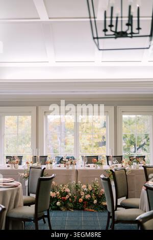 Sunlit space for celebration. Luminous dining area with elegant table settings Stock Photo
