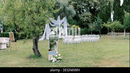 Romantic outdoor wedding setup with lush greenery and soft lighting Stock Photo