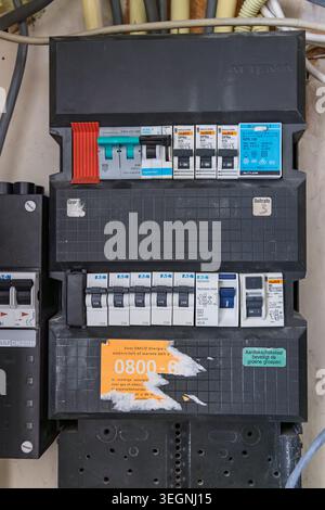 Rotterdam, Netherlands - May 18, 2026: A close-up view of a residential electricity meter box with multiple circuit breakers, switches, and an energy Stock Photo