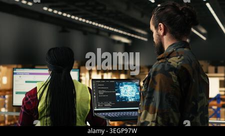 Military personnel operating AI application with advanced data visualization in facility, smart technology interface demonstrates artificial intelligence and innovation. Strengthening security. Stock Photo
