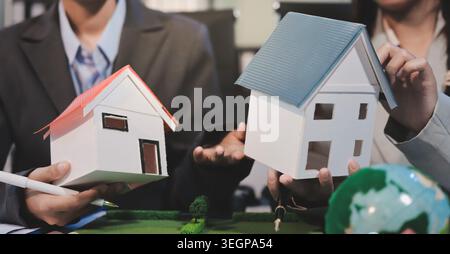 Asian woman lead young group of multiethnic businesspeople in team meeting, using laptop computer for ESG topic presentation on monitor. Sustainable b Stock Photo