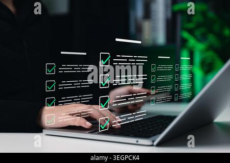 Online assessment and survey concept. Person using laptop with virtual checklist form, check mark, digital questionnaire, online test, exam, quiz, Stock Photo