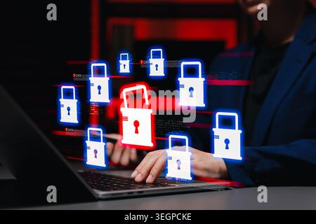 Cyber attack and data breach vulnerability concept. Person using laptop computer, featuring an unlocked red padlock icon among secured blue locks sign Stock Photo