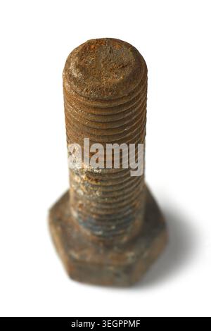heavy old metallic hex bolt covered in brown iron rust isolated white background, oxidized steel hardware in soft focus Stock Photo