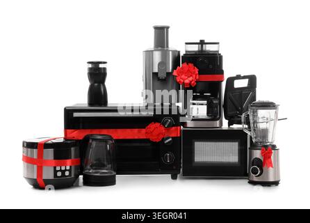 Different household appliances with gift bows isolated on white background Stock Photo