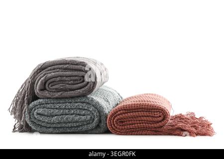 Stack of different knitted blankets isolated on white background Stock Photo