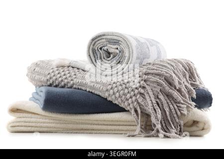 Stack of different soft blankets isolated on white background Stock Photo