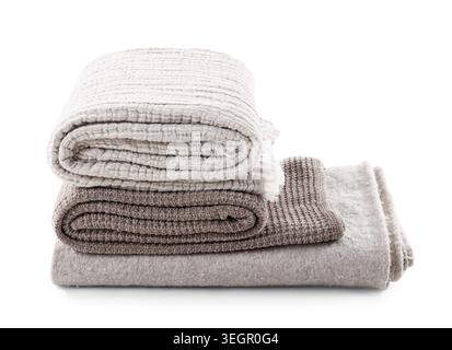 Stack of different cozy blankets isolated on white background Stock Photo