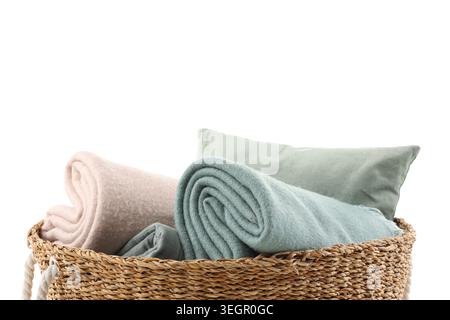 Wicker basket with different cozy blankets isolated on white background Stock Photo