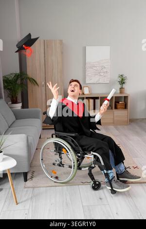 Male graduate in wheelchair with diploma throwing hat at home Stock Photo