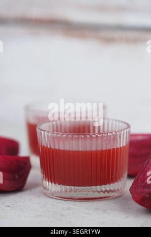 Fresh beetroot juice served in clear glasses on a table Stock Photo