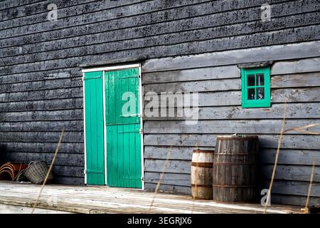 Old wooden barrel on the background of a wooden barn. Selective focus Stock Photo