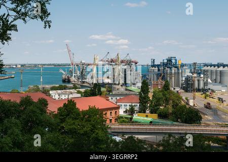 Odesa, Ukraine - July 10, 2025: View of the Odesa seaport and the rooftops of the old Red Warehouses Stock Photo