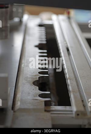 Industrial woodworking machine mechanism operating in a manufacturing environment, showcasing technology, precision, and efficiency in a carpentry pro Stock Photo