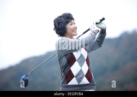 Portrait of smiling senior female golfer Stock Photo