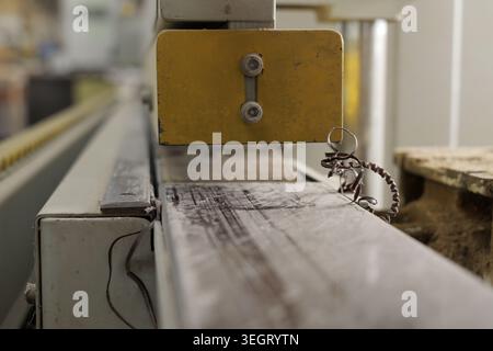 Industrial machine close up showing metal swarf, remnants of a precise cutting or shaping process in a factory workshop, emphasizing engineering and m Stock Photo
