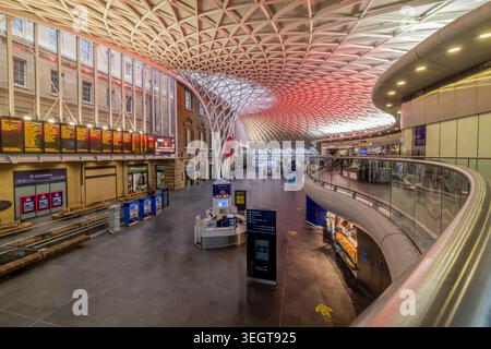 King’s Cross train station in London, a major railway terminus and transport hub with historic architecture and busy platforms. Stock Photo