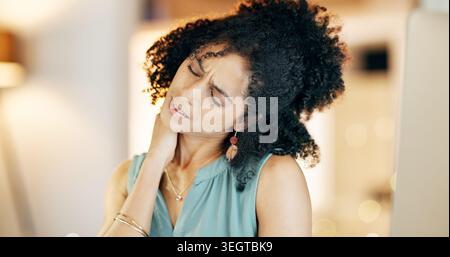 Tired, woman and neck pain in office with computer, bad posture and burnout from overtime at night. Late, exhausted person and fatigue in business Stock Photo