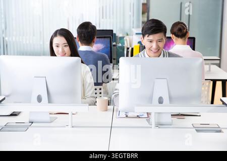 Young Asian professionals working together in a modern office. Stock Photo