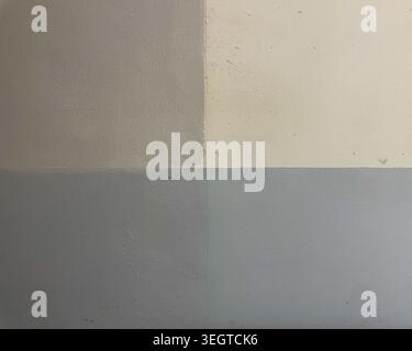 A square grid of wall color samples in varying shades of grey and beige, offering a subtle abstract or background texture. Stock Photo