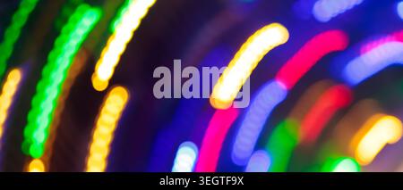 Abstract motion blur of colorful neon light trails with curved streaks for a festive night background Stock Photo