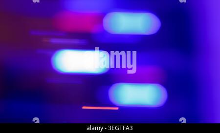 Abstract blurred neon light bokeh background with glowing cyan and purple shapes on dark blue Stock Photo