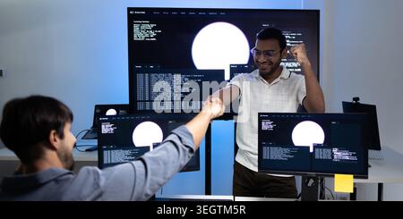 Software Developers Celebrating AI Training Success In Modern Tech Office Stock Photo