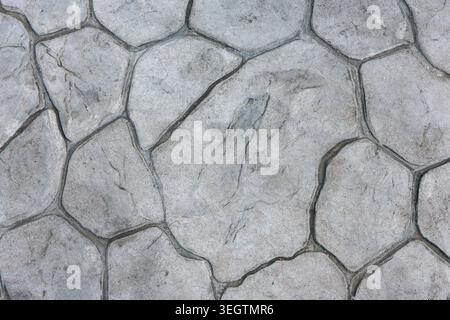 Textured concrete surface resembling natural stone pattern in grey color providing calm, stable, strong foundation for outdoor pavement and abstract b Stock Photo