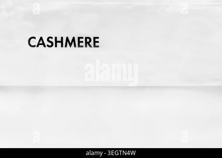 The word Cashmere printed on white plastic background closeup Stock Photo