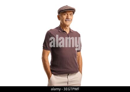 Smiling elderly man wearing a flat cap and polo shirt standing with hands in pockets Stock Photo