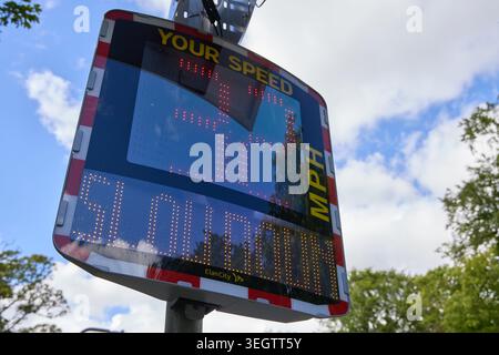 An Elan City speed indicator device (SID) displaying a “slow down” warning to a speeding driver on a UK roadside, used to improve road safety and enco Stock Photo