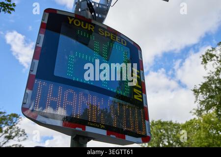 An Elan City speed indicator device (SID) displaying a driver’s current speed and a legal speed limit reminder on a roadside in the UK, used for traff Stock Photo