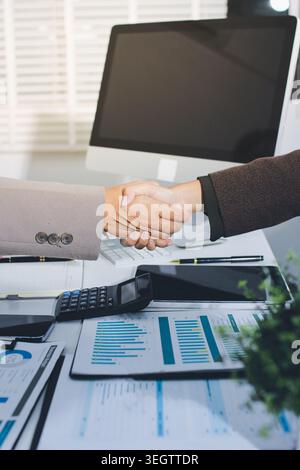 Business people shaking hands finishing up a meeting. Two confident businessman shaking hands during a meeting in the office, success, dealing, greeti Stock Photo