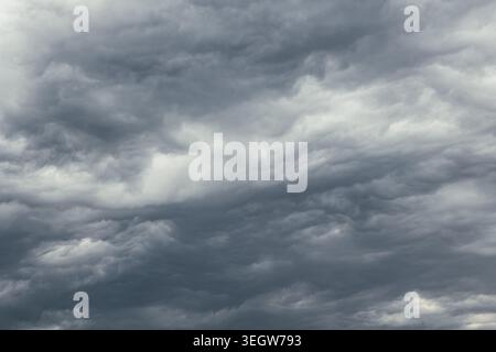 Dramatic sky background. Heavy dark gray clouds in the stormy sky. Stock Photo