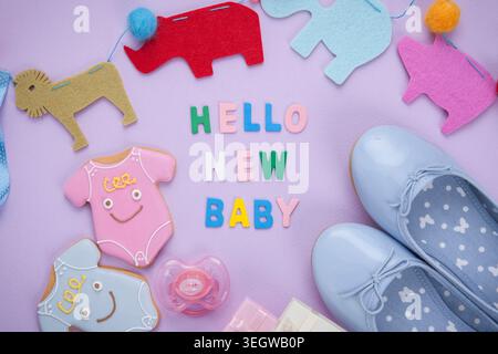 a set of baby items next to a note saying hello new baby Stock Photo