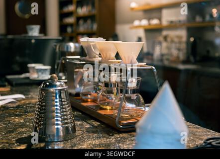 Close-up of a sophisticated coffee pour over setup on a dark granite cafe counter. Stock Photo