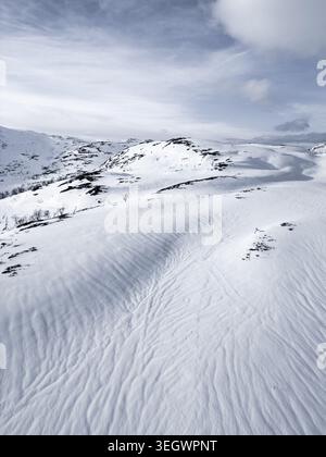 View of wind-blown snow patterns on a frozen surface in Dwukoly ...