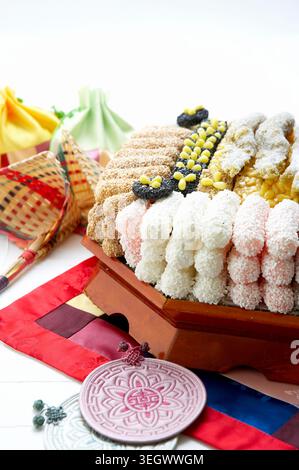 A traditional Korean dessert, yugwa, is arranged in a colorful and decorative manner on a table. Stock Photo