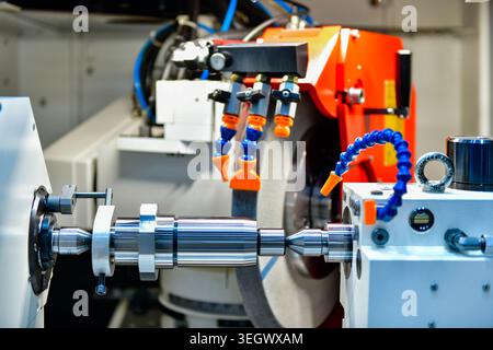 Industrial metal working cutting process The raw material bar clamping on the CNC lathe machine Stock Photo