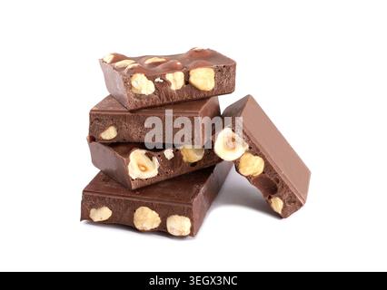 Pieces of chocolate bar with hazelnuts stacked on white background. Stock Photo